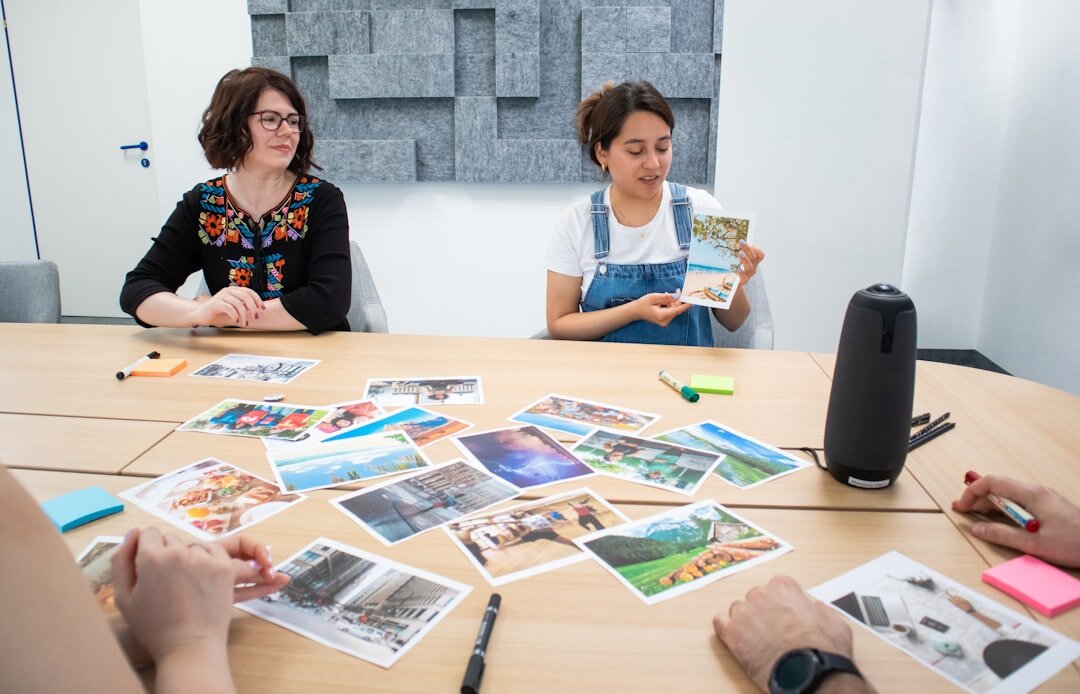 Small editorial team reviewing photographs around a table