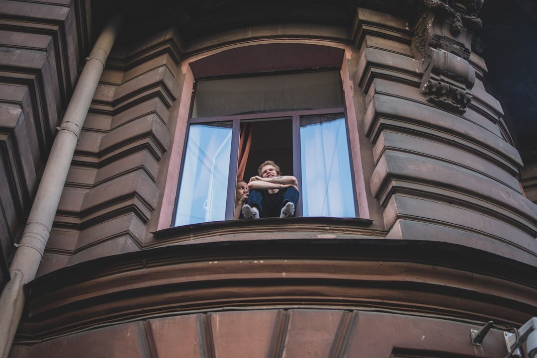 Elderly Croatian woman knitting by a window in a village home