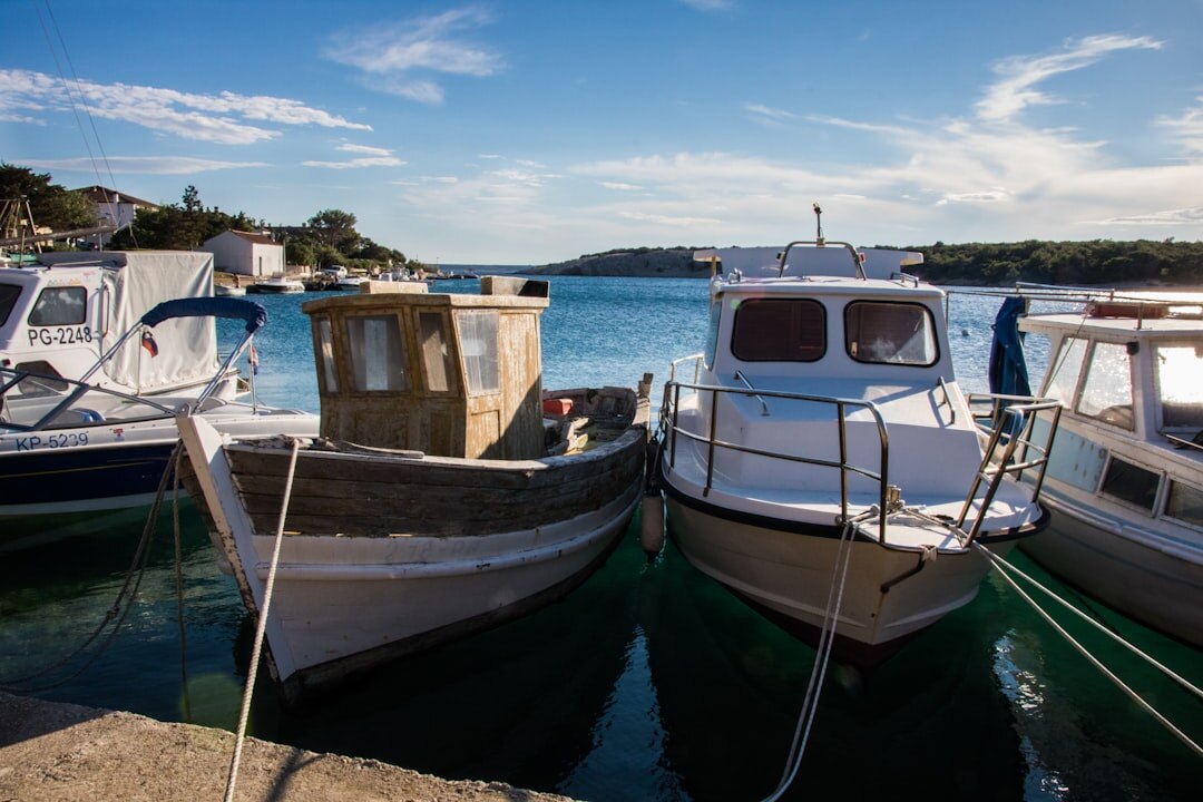 Elderly Croatian fisherman mending nets on a small island harbor