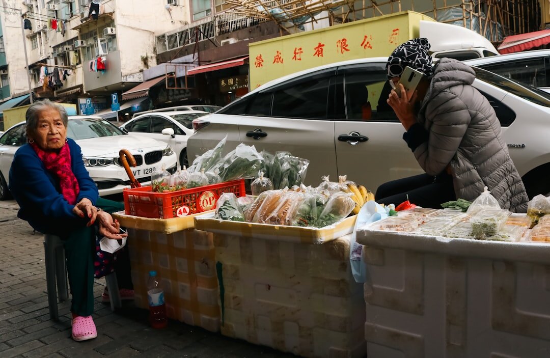 Elderly Croatian woman selling vegetables at a morning market stall